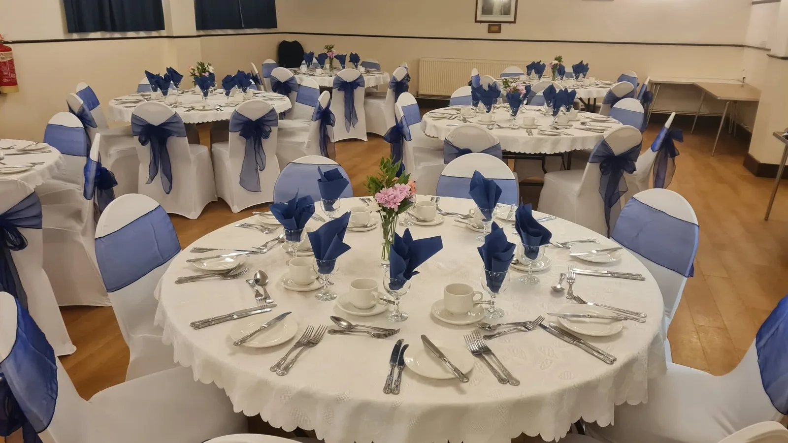 Dining hall arranged with round tables for an event
