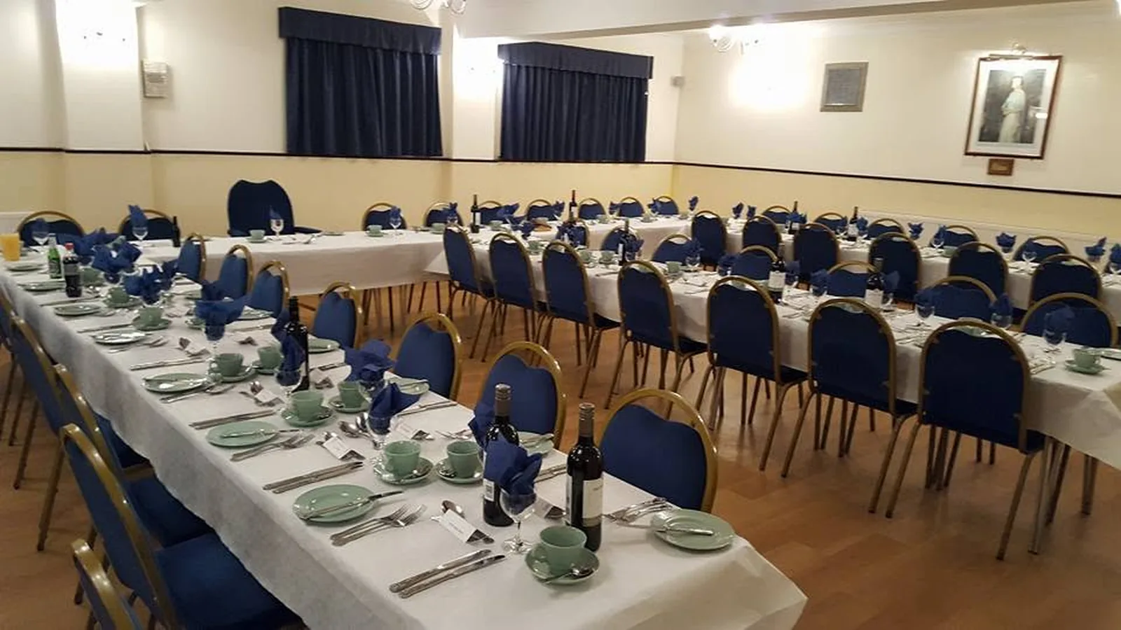 Dining hall arranged with long tables for a meeting or formal meal